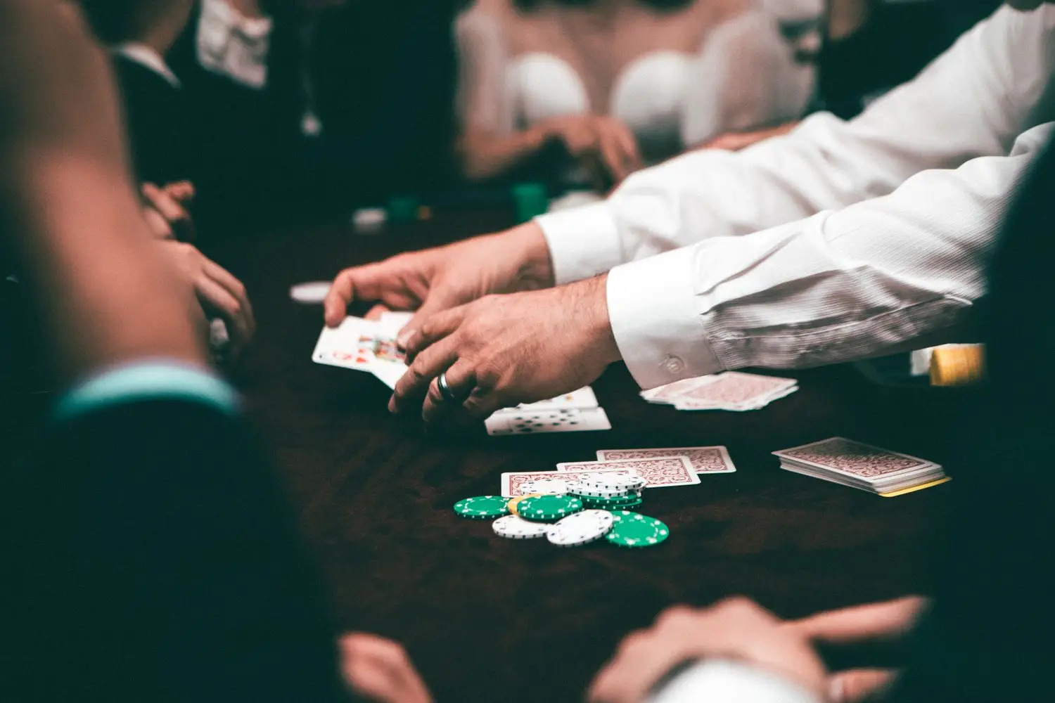 Close view of a high-stakes card table in dramatic light