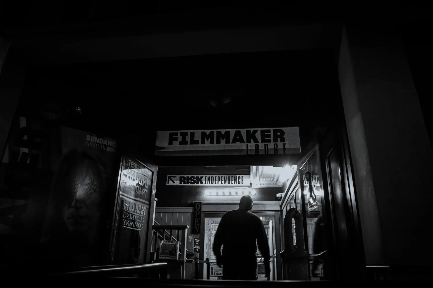 Dark cinema corridor with a filmmaker silhouette