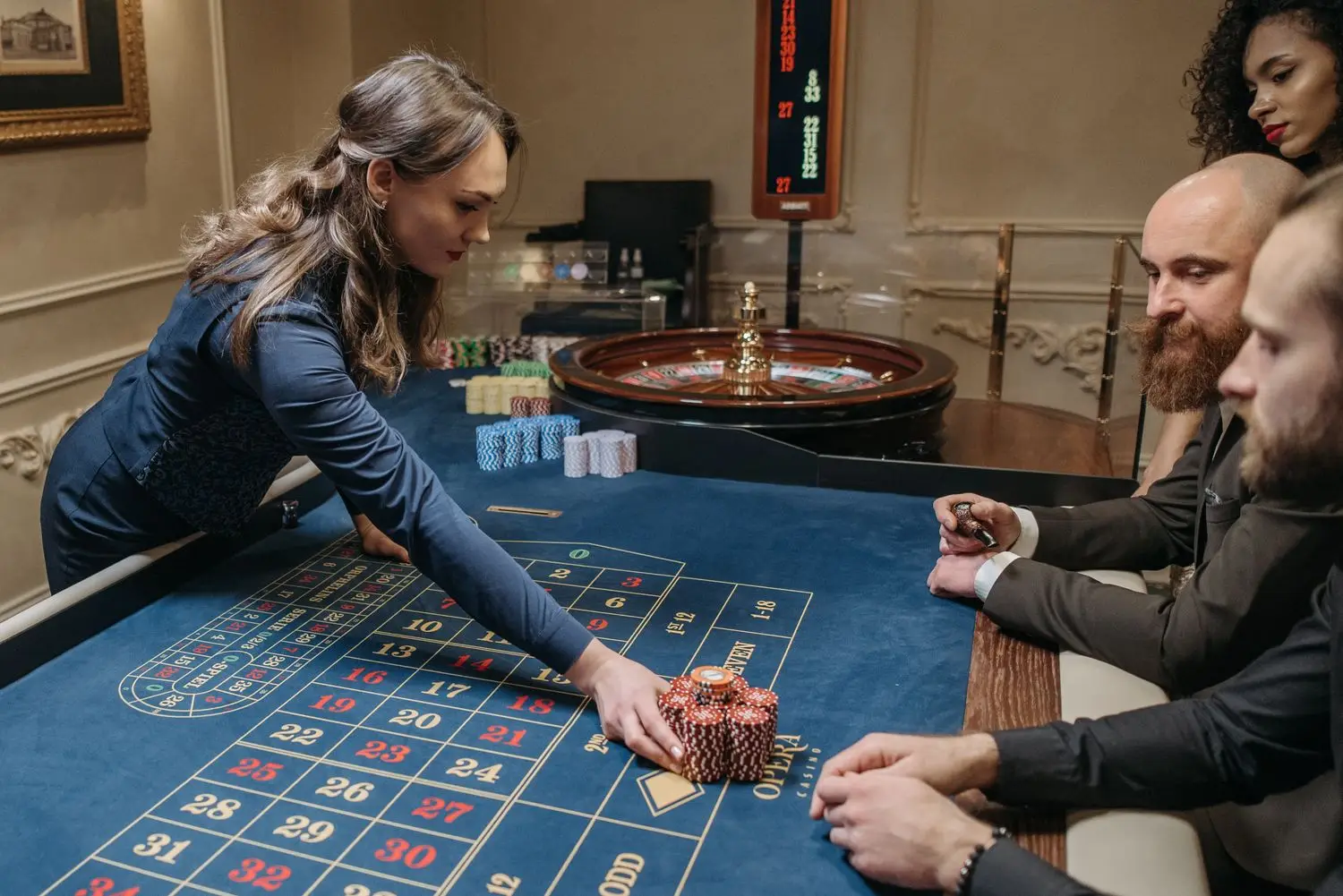 Dealer and players arranged around a cinematic table