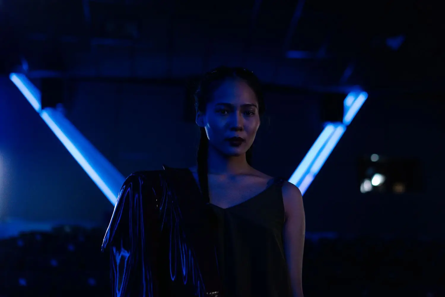 Commanding female portrait under graphic blue light